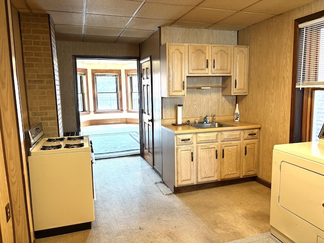 2838 S Keeley St, Chicago, IL 60608 - kitchen featuring white stove, washer / clothes dryer, light colored carpet, wood walls, and light countertops