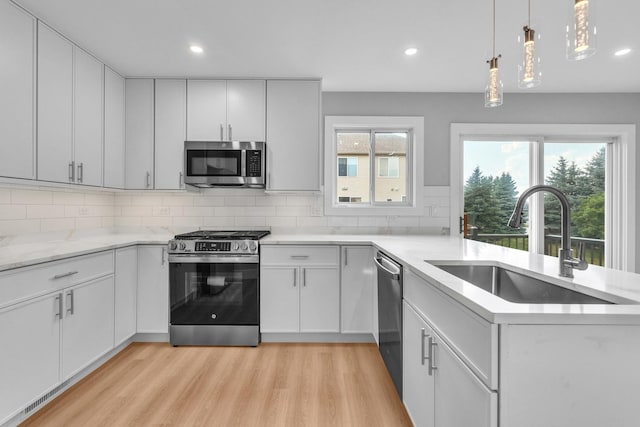 24642 George Washington Dr, Plainfield, IL 60544 - kitchen with stainless steel appliances, light wood-type flooring, a peninsula, plenty of natural light, and recessed lighting