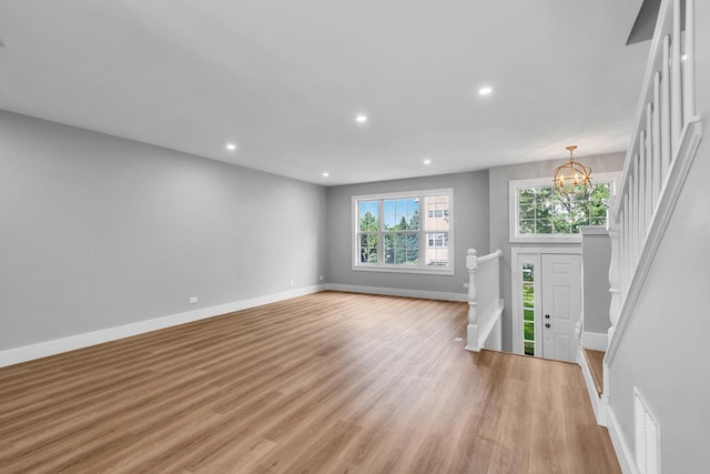 24642 George Washington Dr, Plainfield, IL 60544 - unfurnished living room with a chandelier, light wood finished floors, recessed lighting, and stairway