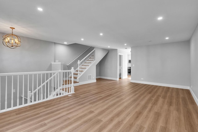 24642 George Washington Dr, Plainfield, IL 60544 - unfurnished living room featuring recessed lighting, light wood finished floors, and a chandelier