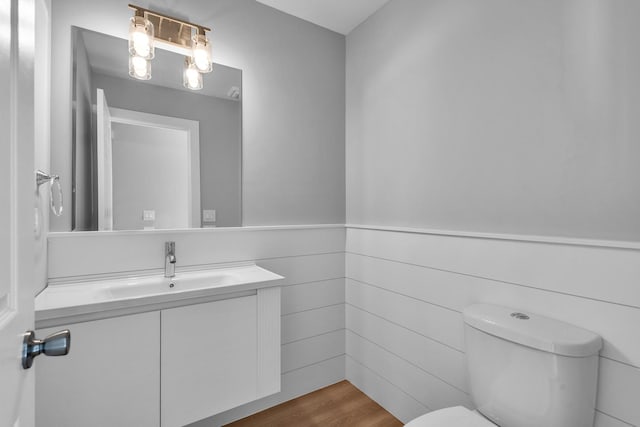 24642 George Washington Dr, Plainfield, IL 60544 - half bath with vanity, wainscoting, and wood finished floors