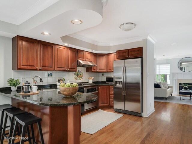 2612 Wilmette Ave, Wilmette, IL 60091 - kitchen with stainless steel refrigerator with ice dispenser, under cabinet range hood, a peninsula, wall oven, and light wood-type flooring