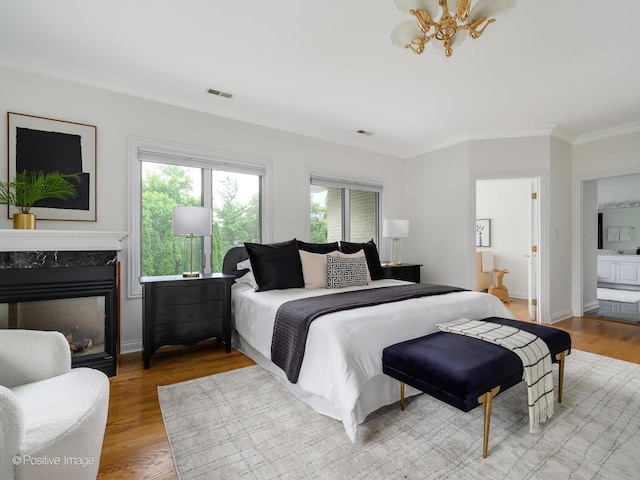 2612 Wilmette Ave, Wilmette, IL 60091 - bedroom featuring crown molding, wood finished floors, a chandelier, a high end fireplace, and connected bathroom