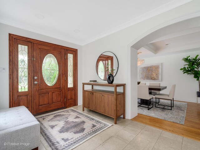 2612 Wilmette Ave, Wilmette, IL 60091 - entrance foyer with arched walkways, ornamental molding, and light tile patterned flooring