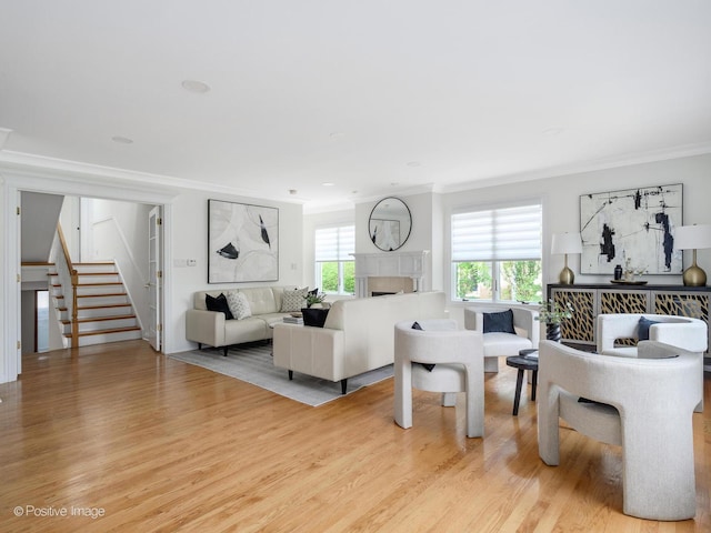2612 Wilmette Ave, Wilmette, IL 60091 - living room with crown molding, stairs, wood finished floors, and a tiled fireplace