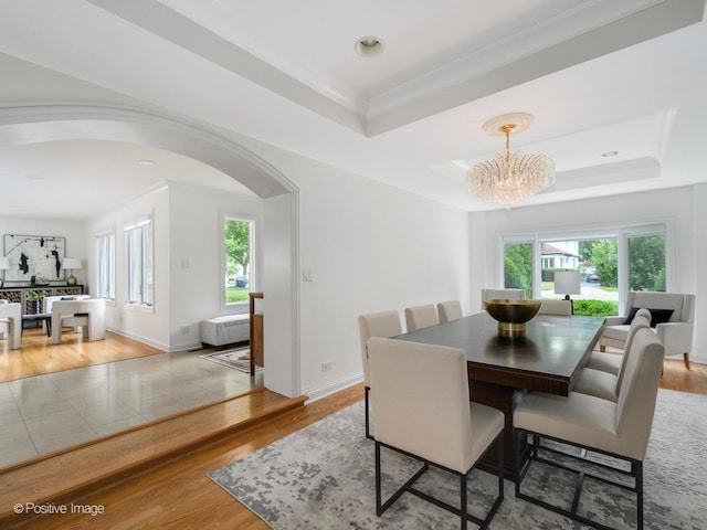 2612 Wilmette Ave, Wilmette, IL 60091 - dining space with a raised ceiling, crown molding, a chandelier, arched walkways, and wood finished floors