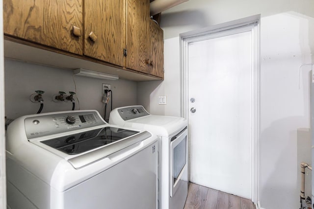 327 Georgetown Ct Unit B, Bloomingdale, IL 60108 - washroom with cabinet space, washer and dryer, and light wood-type flooring