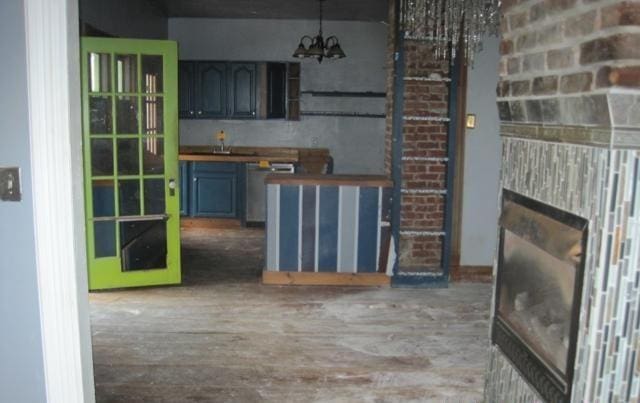 900 Willard St, Galesburg, IL 61401 - kitchen featuring a chandelier, wood finished floors, and hanging light fixtures