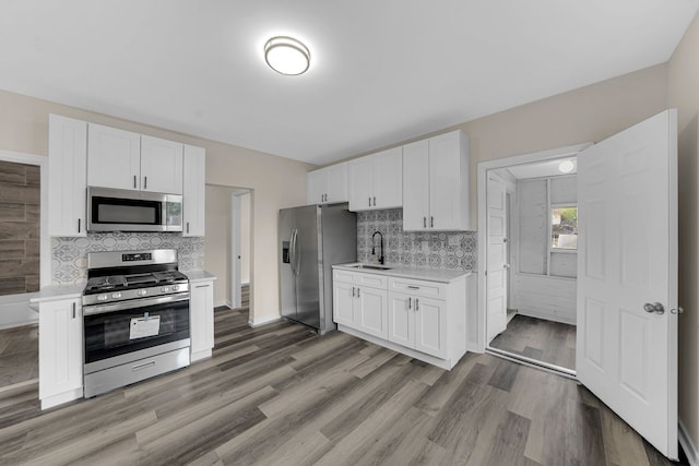 515 George Ave, Waukegan, IL 60085 - kitchen featuring stainless steel appliances, light countertops, backsplash, and white cabinets