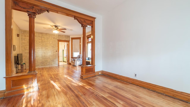 10747 S S Ave H, Chicago, IL 60617 - unfurnished room featuring decorative columns, light wood-type flooring, brick wall, and a ceiling fan