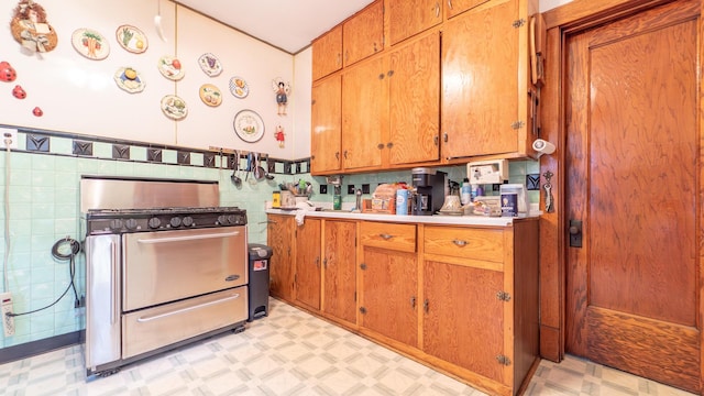 10747 S S Ave H, Chicago, IL 60617 - kitchen featuring double oven range, light flooring, light countertops, brown cabinetry, and tile walls