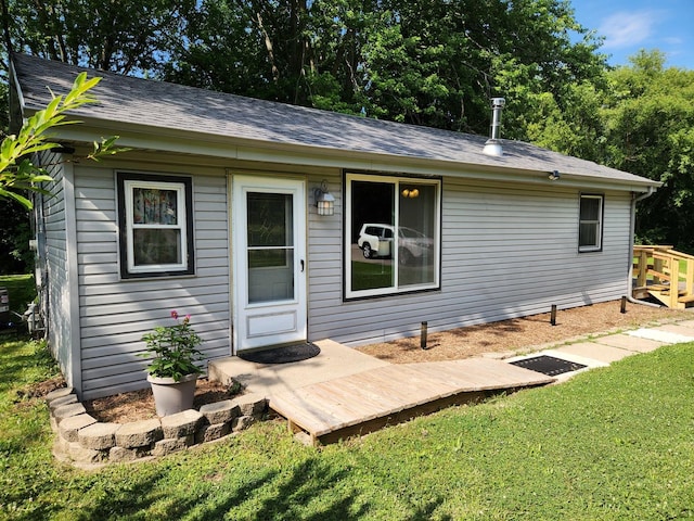 3100 W Brooke Ave, Waukegan, IL 60087 - back of house with a yard and roof with shingles