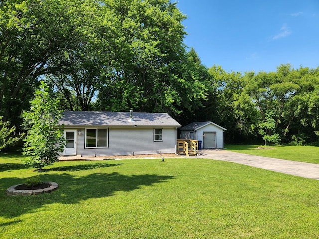 3100 W Brooke Ave, Waukegan, IL 60087 - single story home with an outbuilding, concrete driveway, a front lawn, and a detached garage