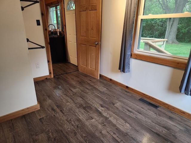 3100 W Brooke Ave, Waukegan, IL 60087 - empty room with baseboards and dark wood-type flooring