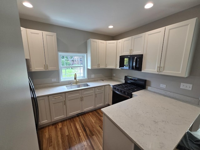 327 Lincoln Ave, Woodstock, IL 60098 - kitchen featuring black appliances, dark wood-style flooring, a peninsula, white cabinetry, and recessed lighting
