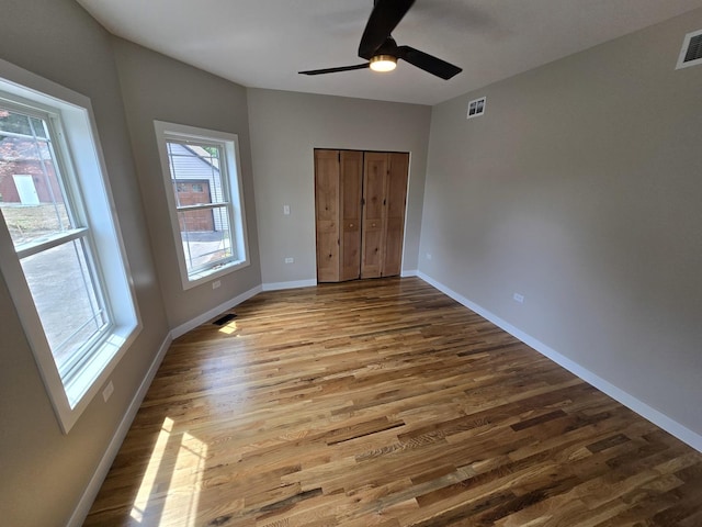 327 Lincoln Ave, Woodstock, IL 60098 - unfurnished bedroom with wood finished floors, a closet, and ceiling fan