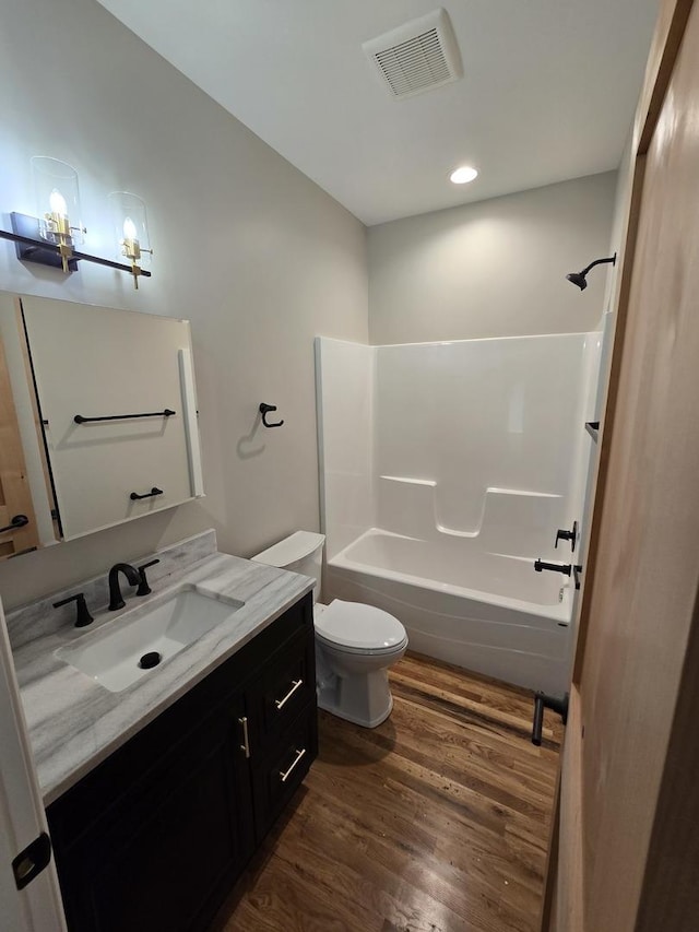 327 Lincoln Ave, Woodstock, IL 60098 - full bathroom with vanity, wood finished floors, washtub / shower combination, and recessed lighting