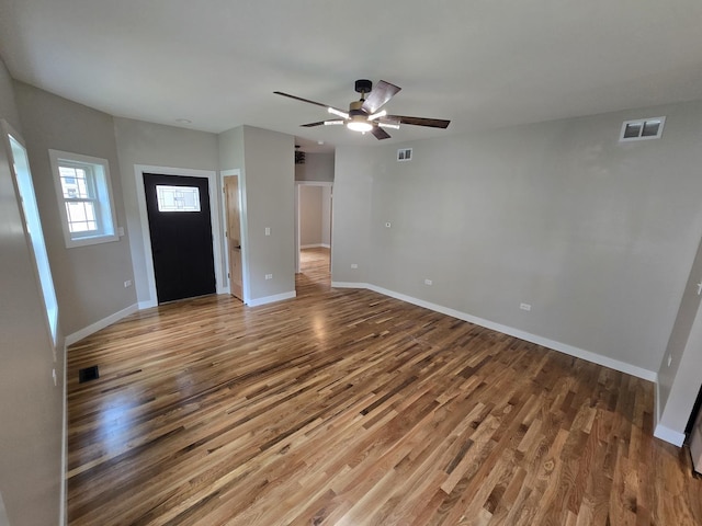 327 Lincoln Ave, Woodstock, IL 60098 - unfurnished living room with wood finished floors and ceiling fan