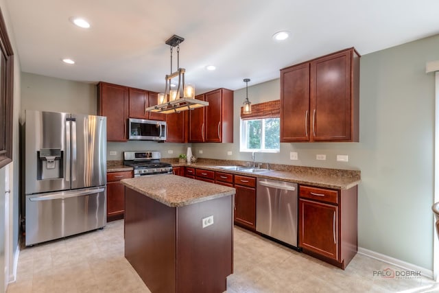 843 Brahms Rd, Volo, IL 60073 - kitchen featuring appliances with stainless steel finishes, hanging light fixtures, a kitchen island, light stone counters, and recessed lighting