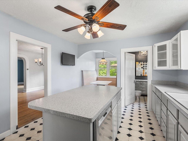 1639 Arlington Ave, Rockford, IL 61107 - kitchen with arched walkways, light floors, light countertops, glass insert cabinets, and a textured ceiling
