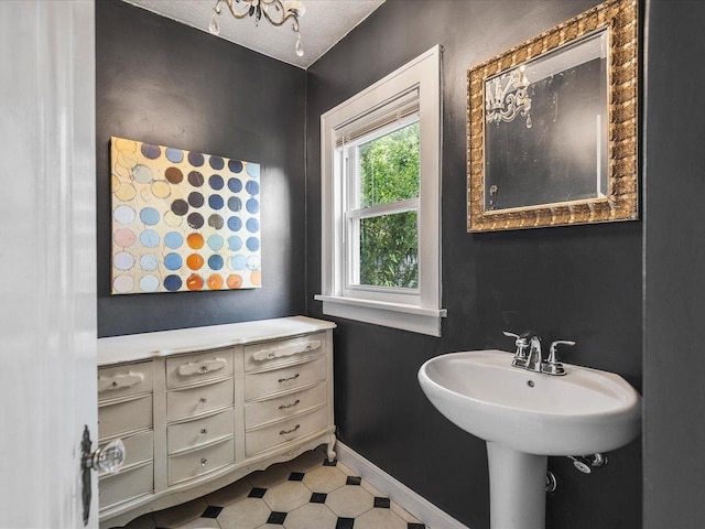 1639 Arlington Ave, Rockford, IL 61107 - bathroom featuring baseboards and a sink