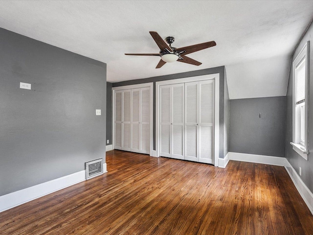 1639 Arlington Ave, Rockford, IL 61107 - unfurnished bedroom with wood finished floors, two closets, ceiling fan, and vaulted ceiling