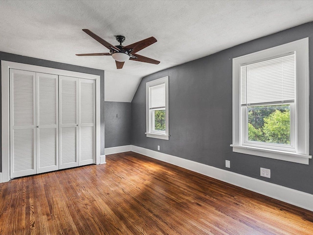 1639 Arlington Ave, Rockford, IL 61107 - unfurnished bedroom with vaulted ceiling, wood finished floors, a closet, a textured ceiling, and ceiling fan