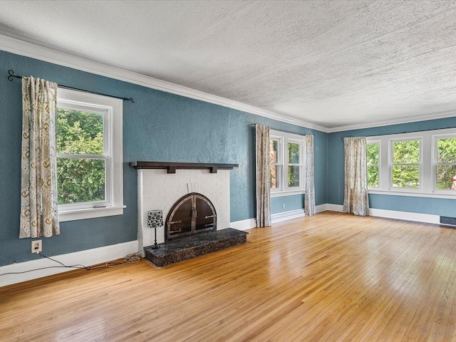 1639 Arlington Ave, Rockford, IL 61107 - unfurnished living room with a textured ceiling, crown molding, wood finished floors, healthy amount of natural light, and a fireplace