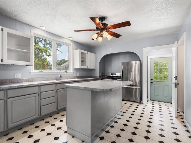 1639 Arlington Ave, Rockford, IL 61107 - kitchen with stainless steel appliances, light flooring, gray cabinets, glass insert cabinets, and a textured ceiling