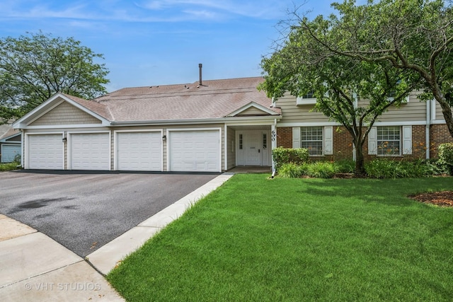 600 Hanover Ct Unit V1, Schaumburg, IL 60194 - view of property featuring driveway, an attached garage, a front yard, and brick siding