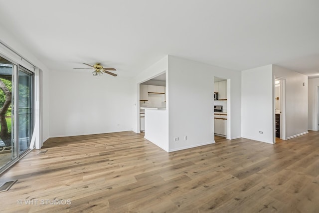 600 Hanover Ct Unit V1, Schaumburg, IL 60194 - unfurnished living room featuring a ceiling fan and light wood-style flooring