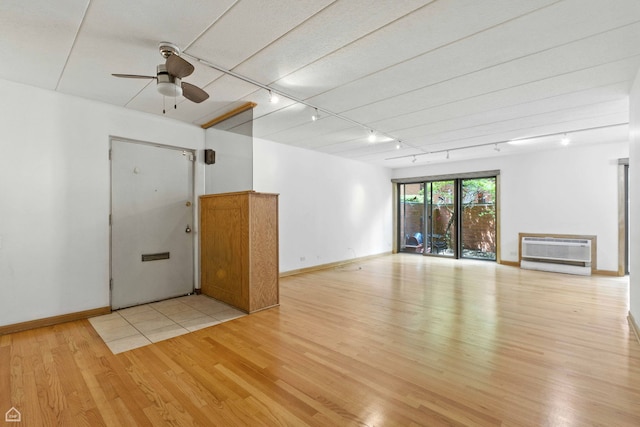 1121 S Plymouth Ct Unit A, Chicago, IL 60605 - unfurnished living room featuring a wall mounted AC, light wood-style floors, rail lighting, and ceiling fan