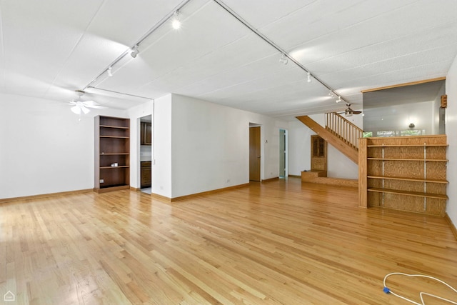 1121 S Plymouth Ct Unit A, Chicago, IL 60605 - unfurnished living room with track lighting, stairway, light wood-style flooring, and a ceiling fan
