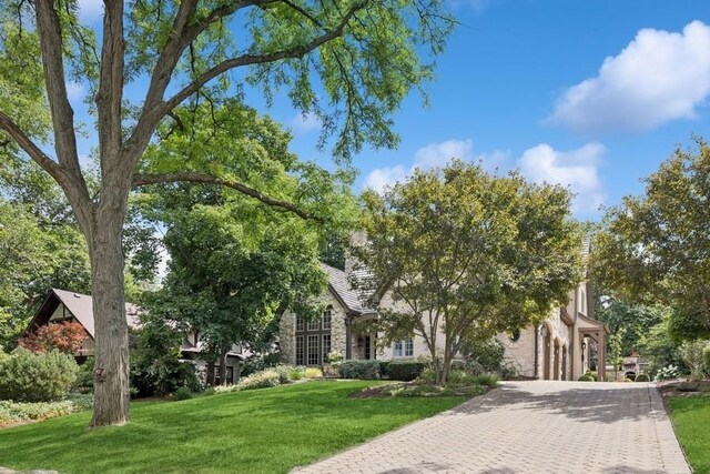 31 Oak St S, Hinsdale, IL 60521 - view of property hidden behind natural elements featuring decorative driveway, a front yard, an attached garage, and stone siding