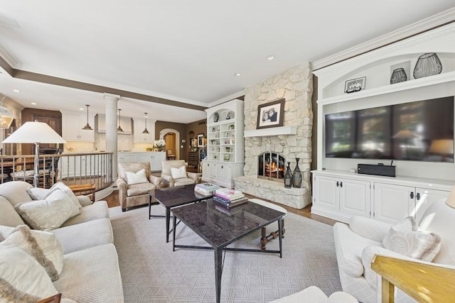 31 Oak St S, Hinsdale, IL 60521 - living area featuring a stone fireplace, arched walkways, wood finished floors, and ornamental molding