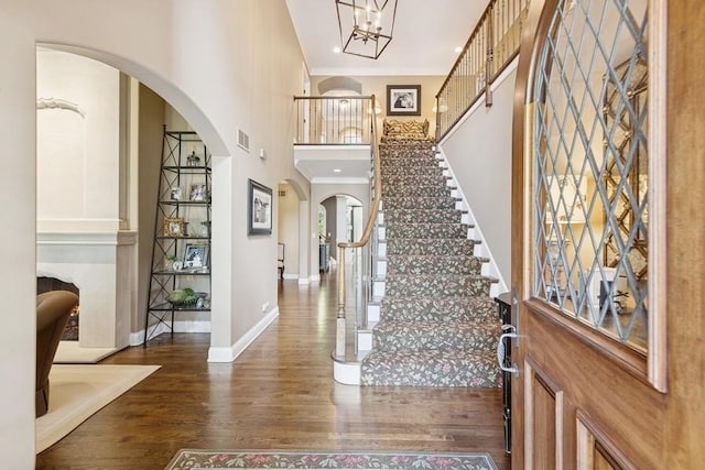 31 Oak St S, Hinsdale, IL 60521 - entrance foyer with ornamental molding, wood finished floors, arched walkways, stairs, and a high ceiling