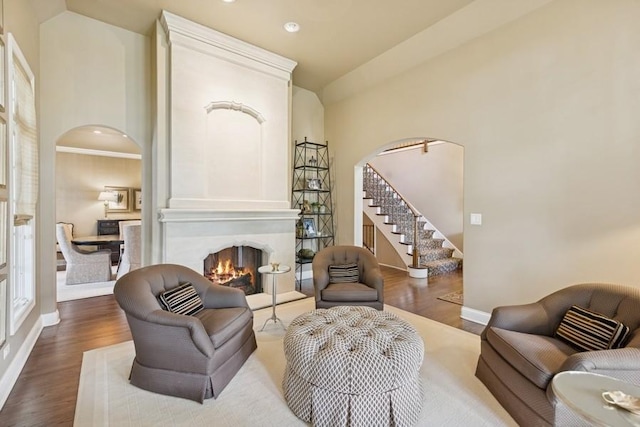 31 Oak St S, Hinsdale, IL 60521 - living room featuring arched walkways, stairway, dark wood-type flooring, a fireplace, and recessed lighting