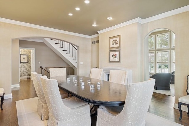31 Oak St S, Hinsdale, IL 60521 - dining space with arched walkways, wood finished floors, crown molding, recessed lighting, and stairway