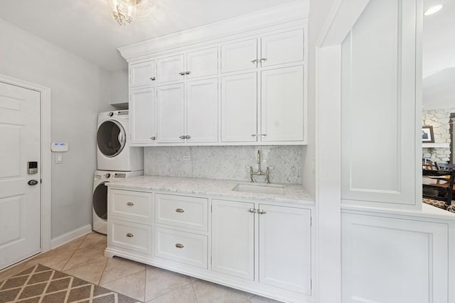 31 Oak St S, Hinsdale, IL 60521 - washroom with stacked washing machine and dryer, cabinet space, and light tile patterned floors