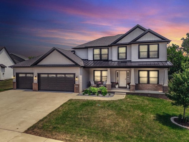 207 Eldon Dr, Downs, IL 61736 - modern farmhouse with brick siding, a standing seam roof, covered porch, and a garage