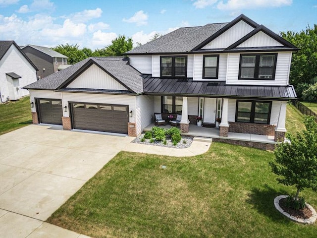 207 Eldon Dr, Downs, IL 61736 - modern farmhouse style home featuring brick siding, a garage, concrete driveway, and a porch
