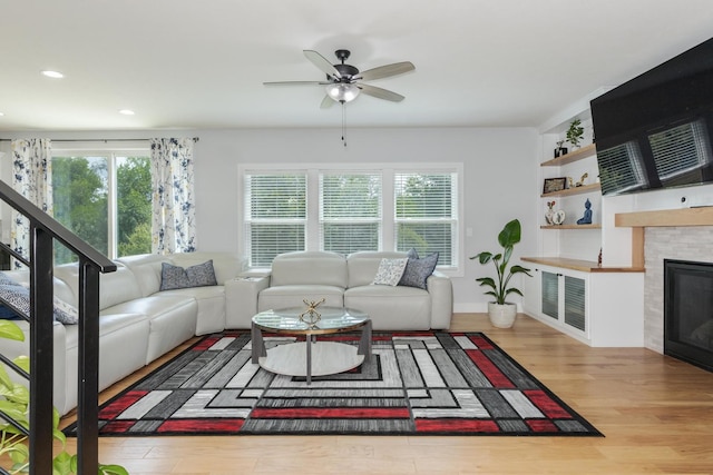 207 Eldon Dr, Downs, IL 61736 - living area featuring healthy amount of natural light, wood finished floors, a ceiling fan, recessed lighting, and a glass covered fireplace
