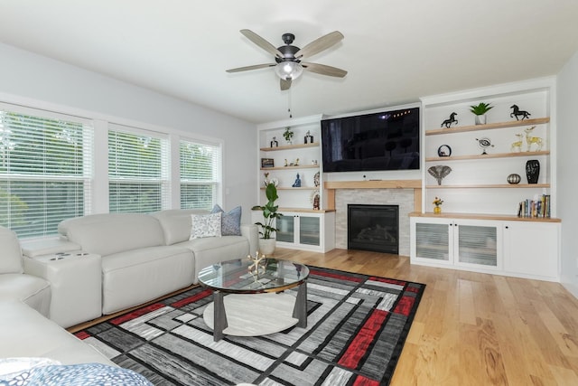 207 Eldon Dr, Downs, IL 61736 - living room with wood finished floors, a ceiling fan, and a glass covered fireplace