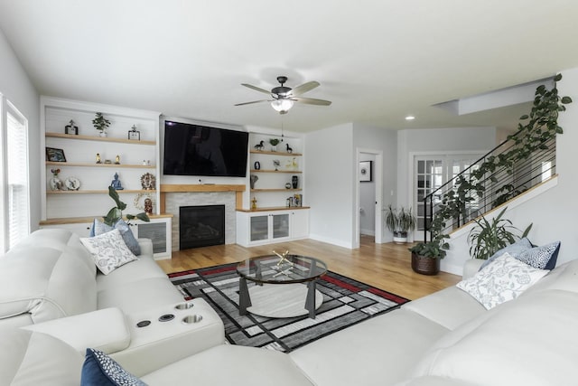 207 Eldon Dr, Downs, IL 61736 - living area with a ceiling fan, wood finished floors, and a glass covered fireplace