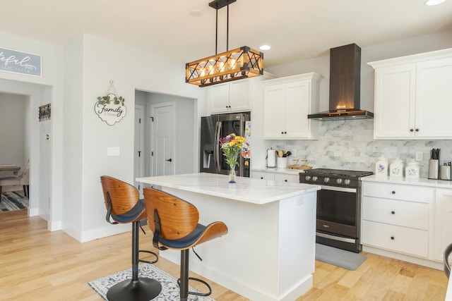 207 Eldon Dr, Downs, IL 61736 - kitchen with appliances with stainless steel finishes, wall chimney range hood, decorative backsplash, white cabinetry, and light wood-style floors