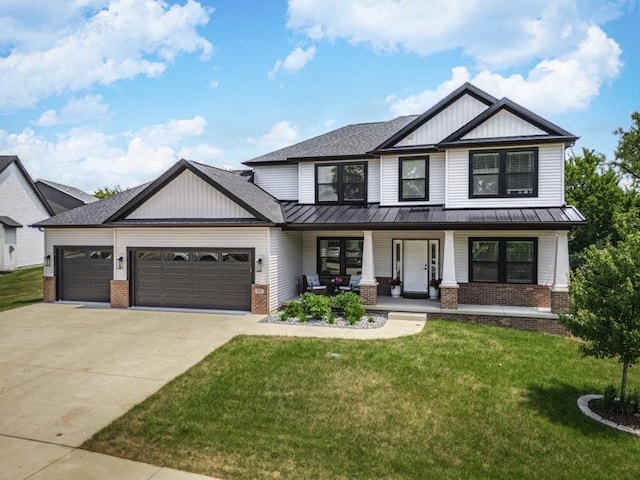 207 Eldon Dr, Downs, IL 61736 - view of front of home with brick siding, a garage, a standing seam roof, and concrete driveway