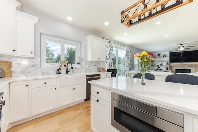 207 Eldon Dr, Downs, IL 61736 - kitchen with appliances with stainless steel finishes, recessed lighting, a ceiling fan, light wood-type flooring, and tasteful backsplash
