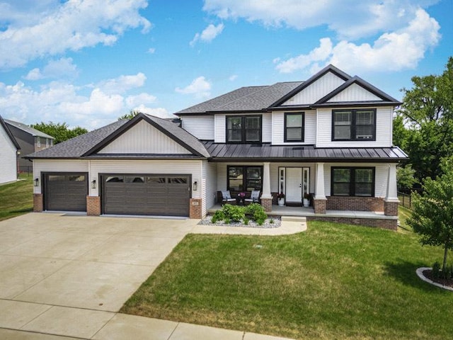 207 Eldon Dr, Downs, IL 61736 - view of front facade featuring brick siding, a standing seam roof, covered porch, and an attached garage