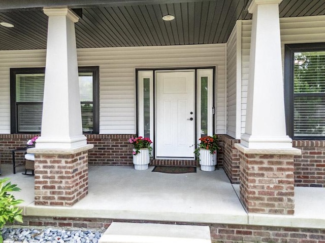 207 Eldon Dr, Downs, IL 61736 - doorway to property with a porch and brick siding