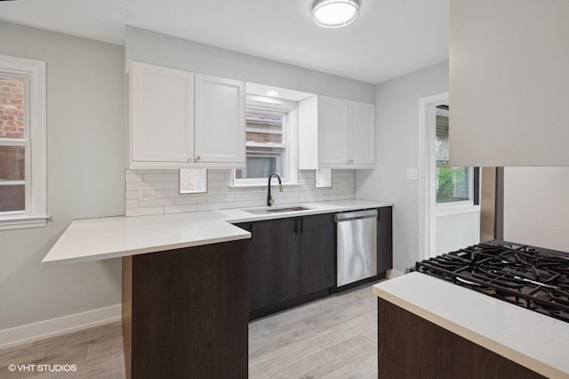 5406 N Mulligan Ave, Chicago, IL 60630 - kitchen featuring dishwasher, white cabinets, backsplash, light wood-style flooring, and light countertops